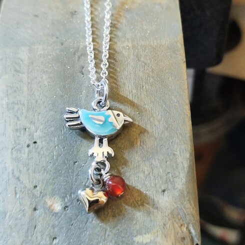 Little blue lovebird with berry